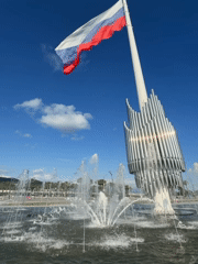 Afternoon at Sirius plaza: fountain, flag, and people out