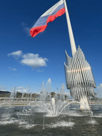 Afternoon at Sirius plaza: fountain, flag, and people out