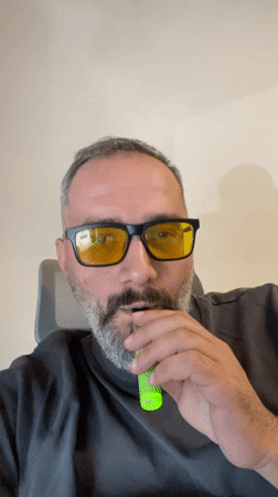 Tbilisi office desk scene with laptop, vape, and motivational poster