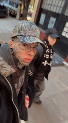 Tattooed individual filmed on Buenos Aires street mentions Iceland trip