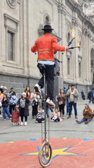 Fire juggling unicyclist performs in Santiago square