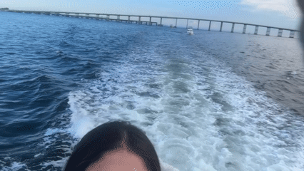 Evening boat ride through Miami bay near bridge