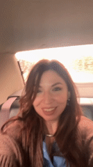 Woman photographed smiling in car during rainy day in Ukraine
