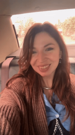 Woman photographed smiling in car during rainy day in Ukraine