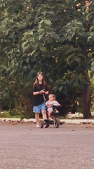 Everyday street activity in a Tashkent neighborhood on a summer afternoon.