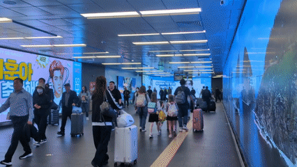 Late-night activity captured at Seoul subway station with advertising displays