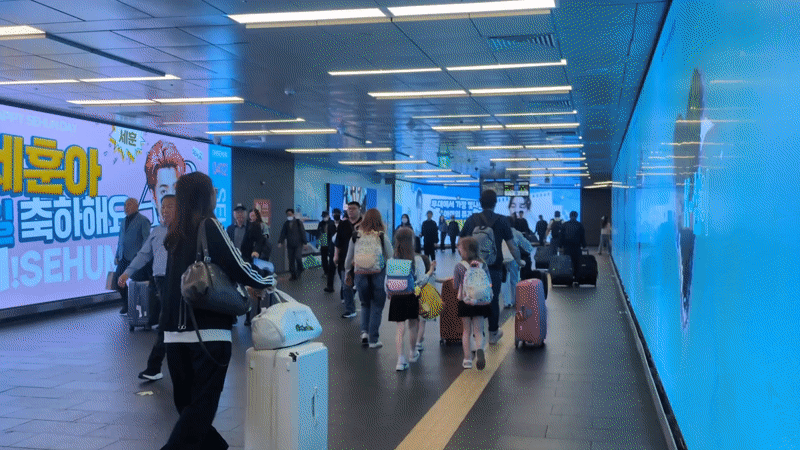 Late-night activity captured at Seoul subway station with advertising displays