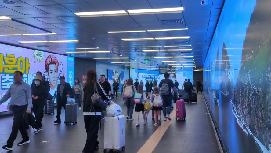Late-night activity captured at Seoul subway station with advertising displays