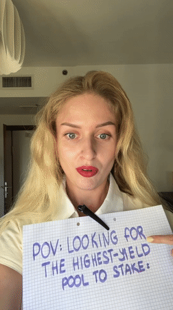 Woman uses magnifying glass in cryptocurrency staking demonstration