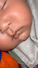 Sleeping baby on a star-patterned blanket in Kyrgyzstan