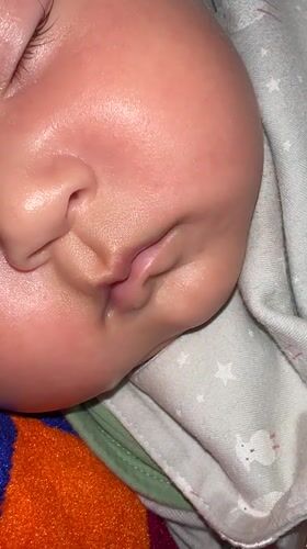 Sleeping baby on a star-patterned blanket in Kyrgyzstan