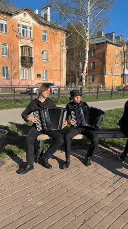 Street musicians perform amid instrument displays in Votkinsk