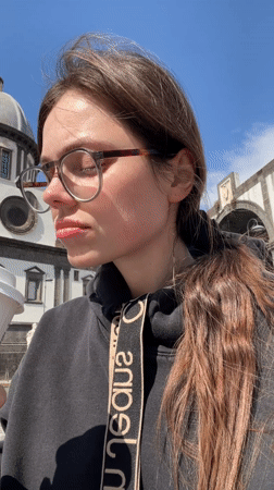 Woman enjoys Starbucks coffee in historic Naples square