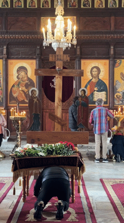 Person prays in Tsarevo church amid religious iconography