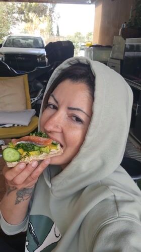 Woman enjoys early morning meal in Israeli countryside