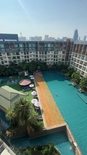 Morning aerial view of Pattaya condominium pool complex captured