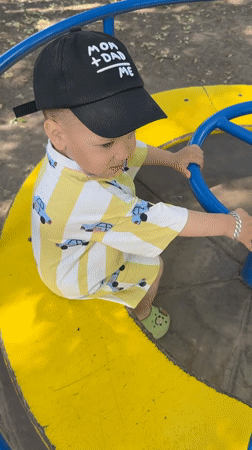 Toddler plays on playground carousel in Rusanovo, Russia