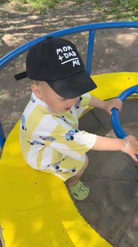 Toddler plays on playground carousel in Rusanovo, Russia