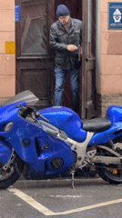 Man exits building during downpour in Saint Petersburg