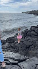 Pink tutu on black lava rock at the Hawaii coast