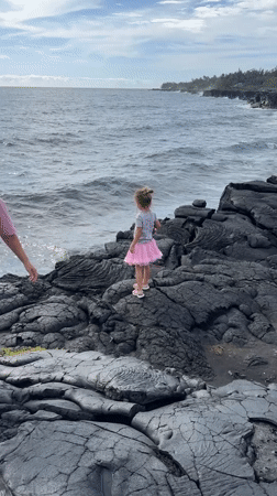 Pink tutu on black lava rock at the Hawaii coast