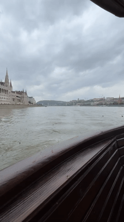 Tourist boat captures Parliament Building views along Budapest's Danube River