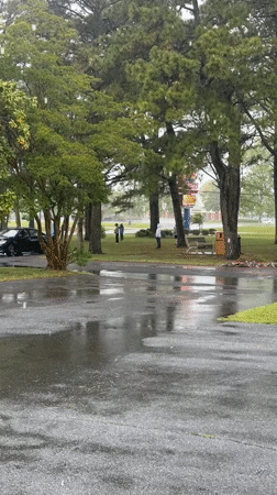 Children play ball game in rain, West Ocean City