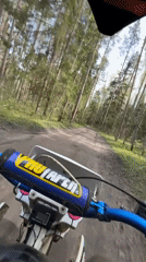 Dirt bike rider travels forest trails near Kirovsk