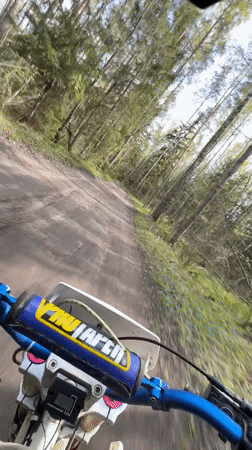 Dirt bike rider travels forest trails near Kirovsk