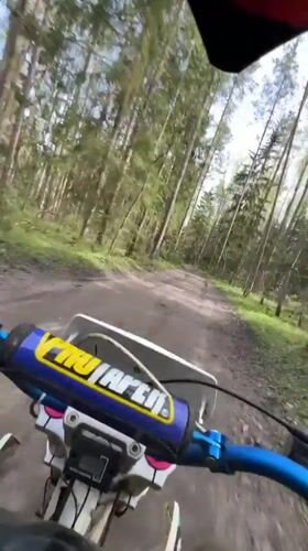 Dirt bike rider travels forest trails near Kirovsk
