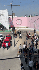 Crowd gathers for photo session at Puebla commercial lot